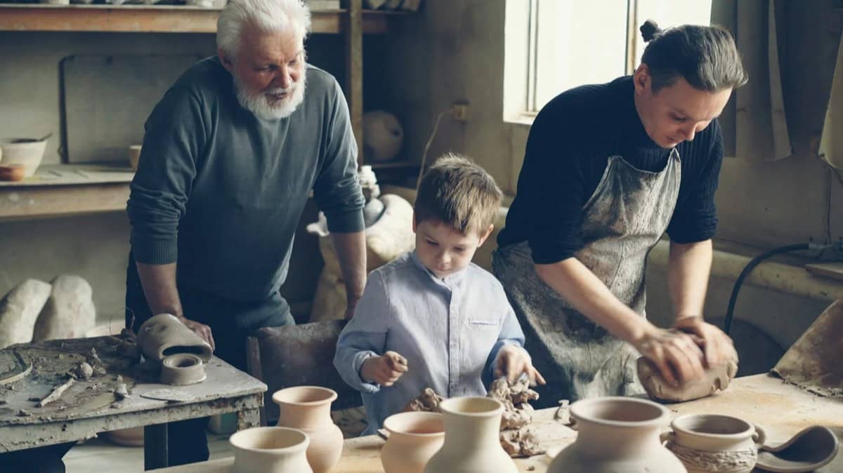 Three generations at a pottery wheel