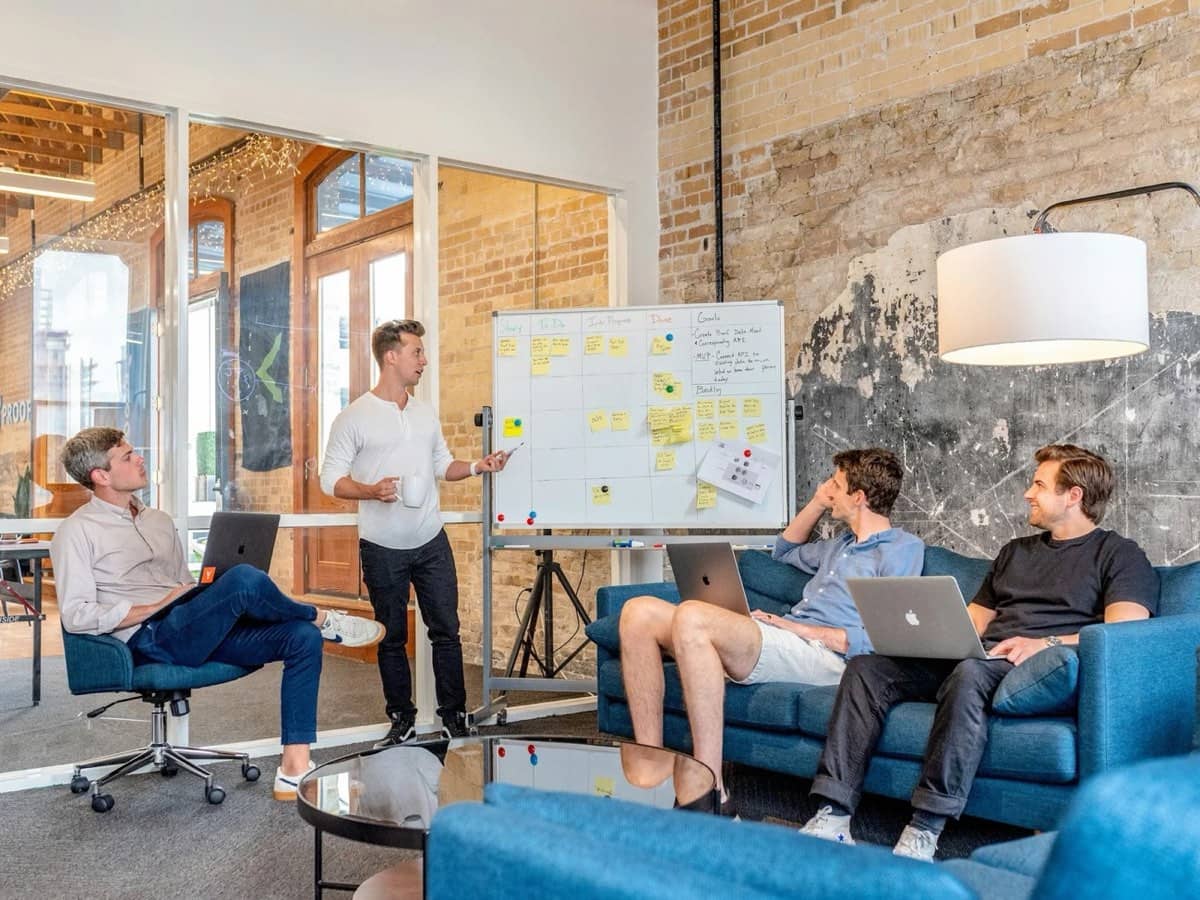 A team meeting around a whiteboard